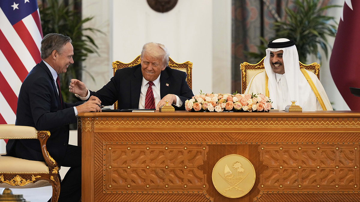 President Donald Trump, center, Qatar's Emir Sheikh Tamim bin Hamad Al Thani and Kelly Ortberg, President and Chief Executive Officer, The Boeing Company, left, share a moment during a signing ceremony at the Amiri Diwan in Doha, Qatar, Wednesday, May 14, 2025.